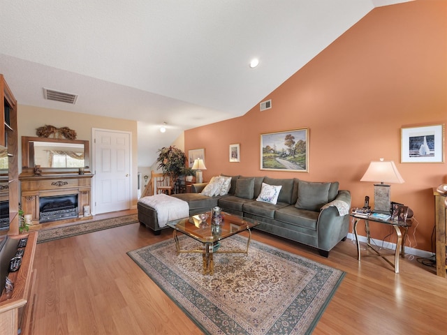 living room featuring light hardwood / wood-style floors and lofted ceiling