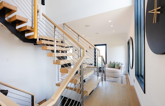 staircase with hardwood / wood-style flooring