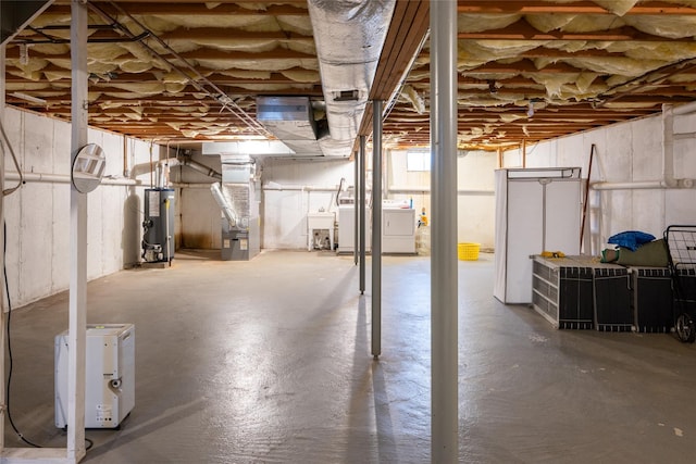 2555 Youngs Unit 7D, Southold, NY 11971 - unfinished below grade area featuring water heater, heating unit, separate washer and dryer, and a sink
