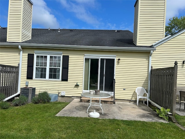 2555 Youngs Unit 7D, Southold, NY 11971 - rear view of property featuring a chimney, a patio, central AC unit, and a shingled roof