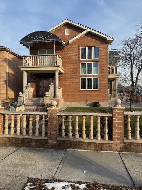 view of front of house featuring a balcony