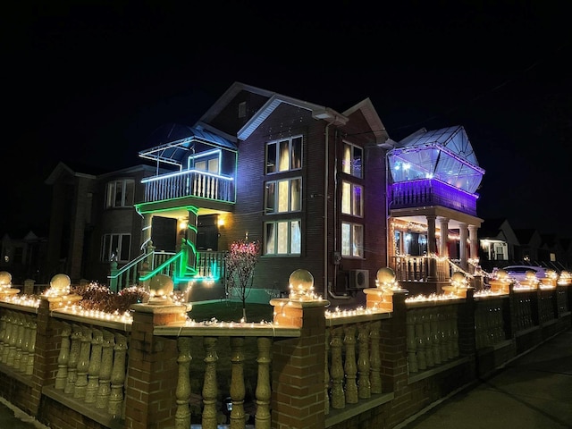 back house at twilight with a balcony