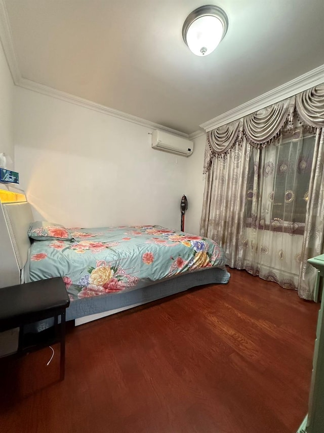 bedroom featuring dark wood-type flooring, a wall mounted AC, and crown molding