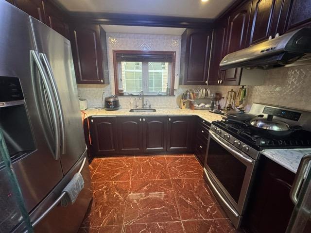 kitchen featuring sink, dark brown cabinetry, and appliances with stainless steel finishes