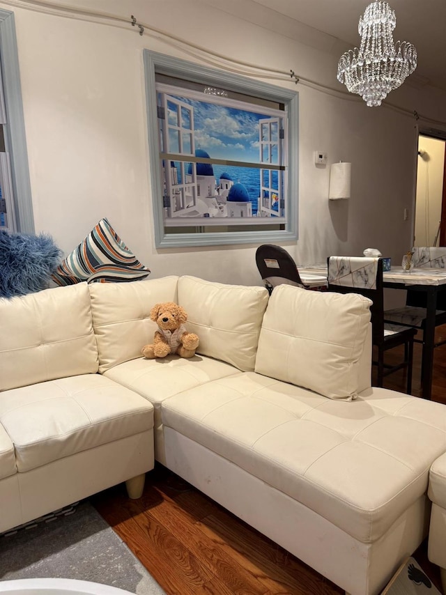 living room featuring a chandelier and dark hardwood / wood-style flooring