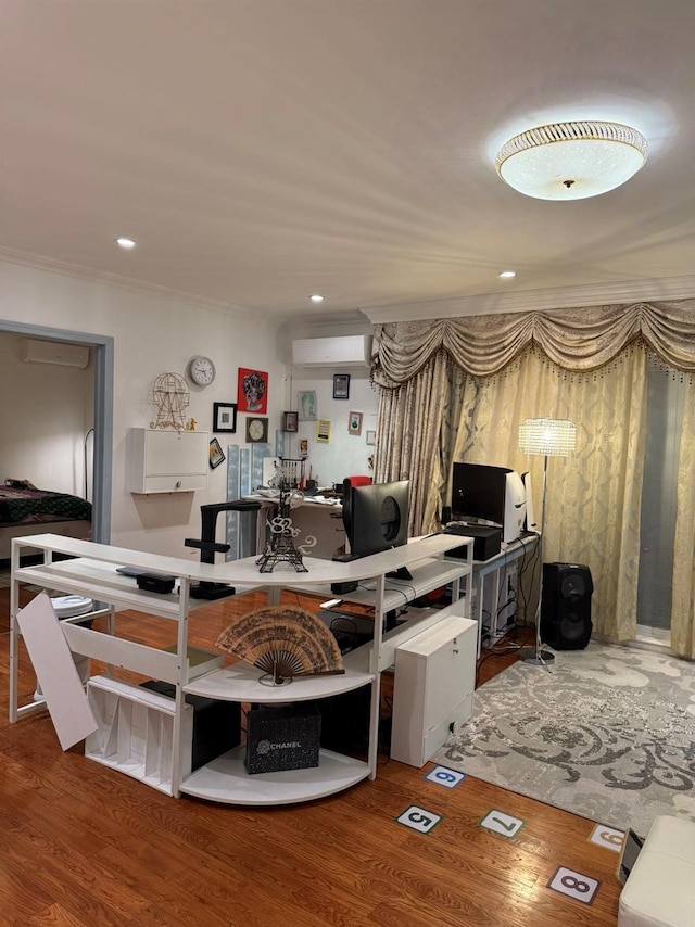 interior space with an AC wall unit, crown molding, and hardwood / wood-style floors