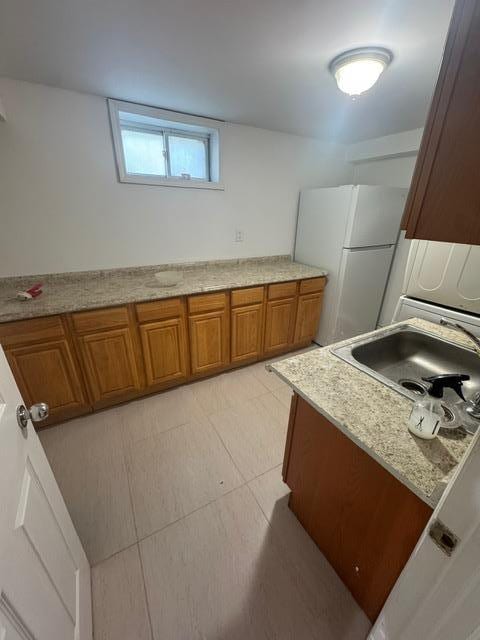 kitchen featuring sink and white refrigerator