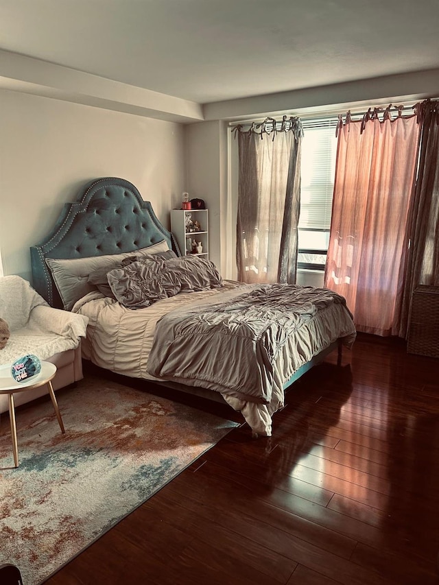 bedroom with dark wood-type flooring