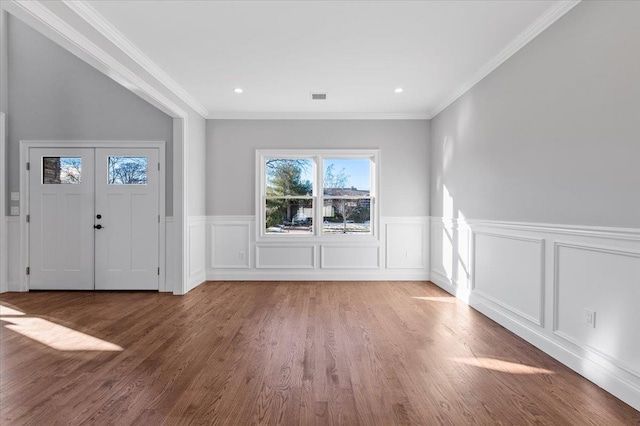 entrance foyer featuring crown molding and hardwood / wood-style flooring