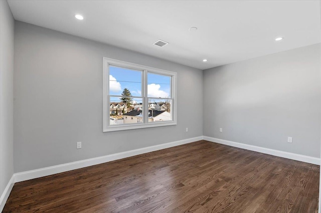 empty room featuring dark hardwood / wood-style flooring