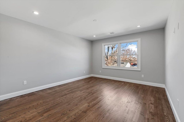 empty room with dark hardwood / wood-style floors