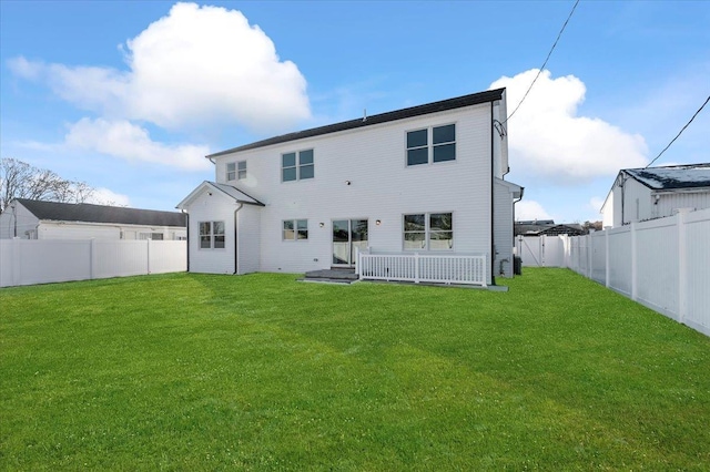 rear view of property with a yard