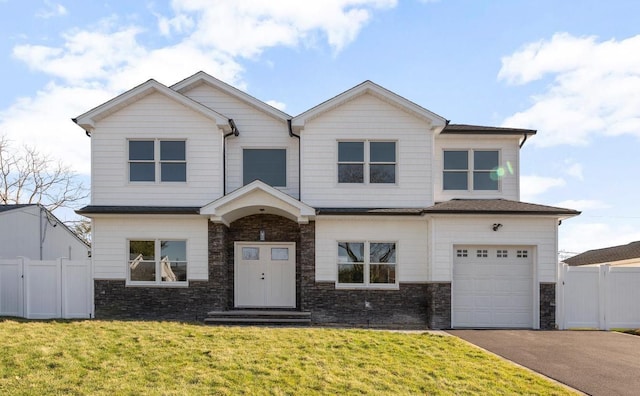 view of front of property featuring a front yard and a garage