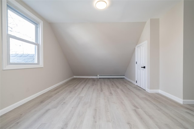 bonus room featuring light hardwood / wood-style floors, lofted ceiling, and baseboard heating