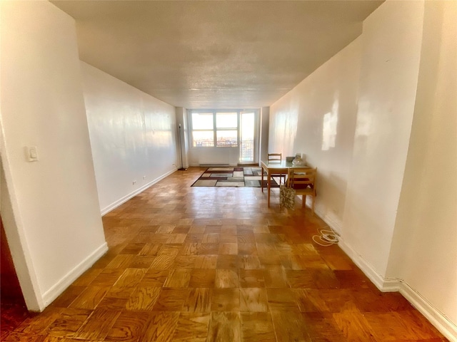 hallway featuring parquet flooring and baseboard heating