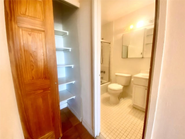 full bathroom featuring vanity, bath / shower combo with glass door, and toilet