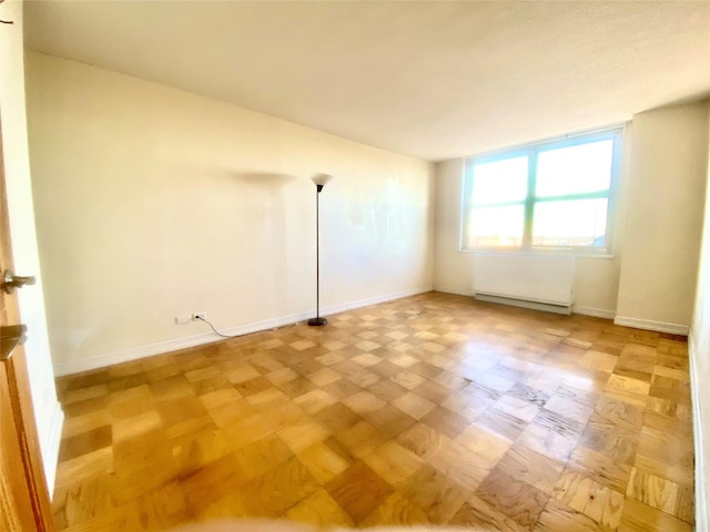 unfurnished room with parquet flooring