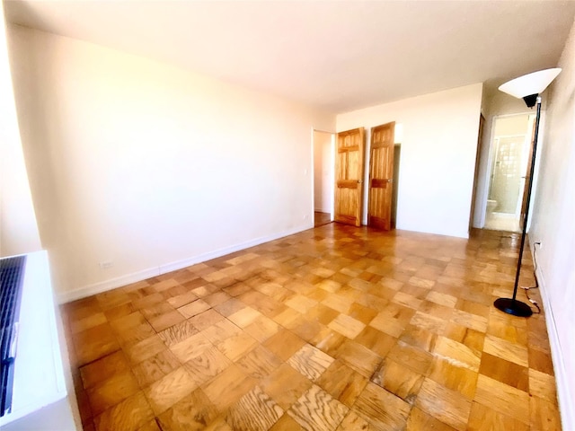 spare room featuring parquet flooring