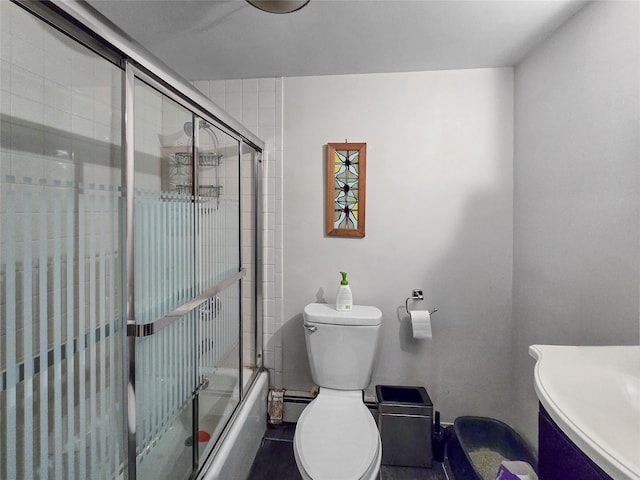 bathroom featuring toilet and combined bath / shower with glass door