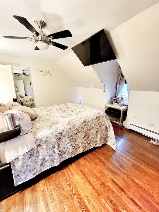 bedroom featuring vaulted ceiling, ceiling fan, baseboard heating, and hardwood / wood-style flooring