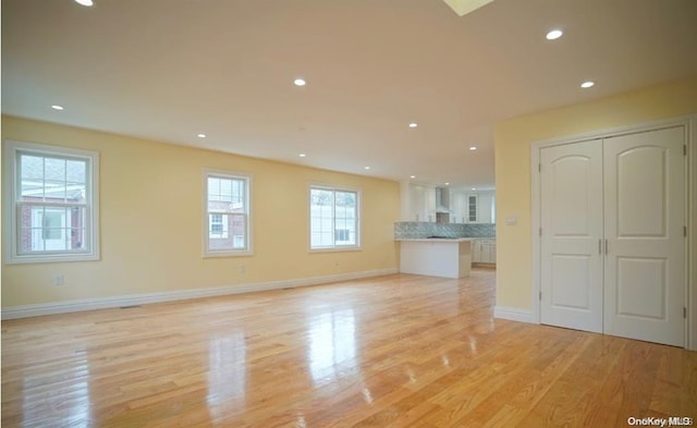 unfurnished living room featuring light wood-type flooring