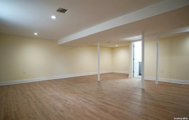 basement featuring hardwood / wood-style flooring