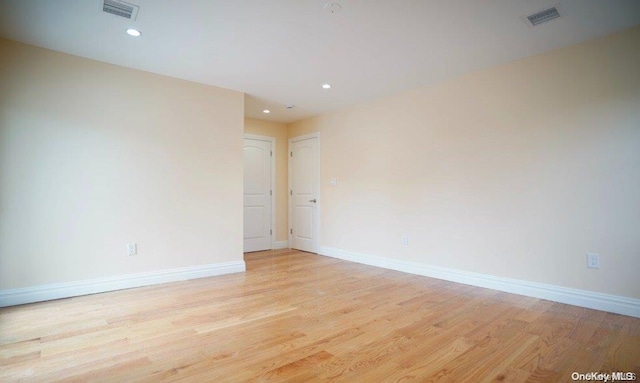 spare room featuring light hardwood / wood-style flooring