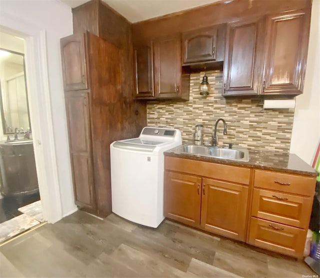 washroom featuring cabinets, washer / clothes dryer, and sink