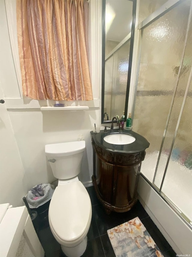 full bathroom with tile patterned flooring, vanity, toilet, and combined bath / shower with glass door