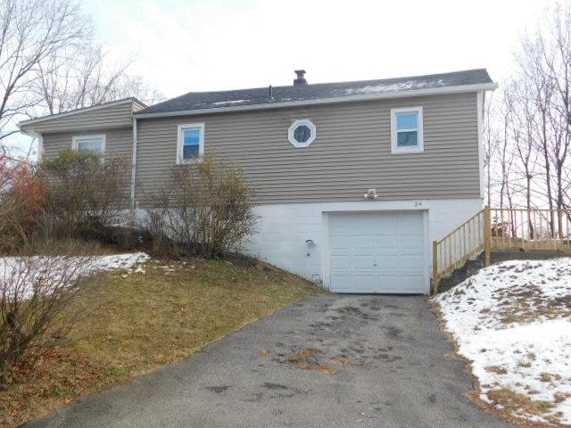 view of snow covered exterior featuring a garage