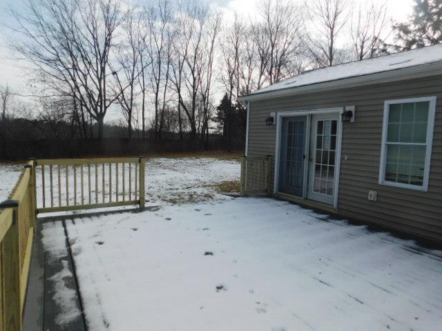 snow covered deck with french doors