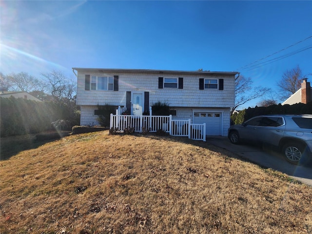 split foyer home with a front yard and a garage