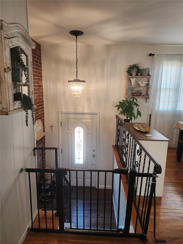 entryway featuring dark hardwood / wood-style flooring and a chandelier