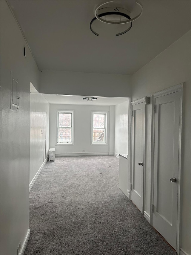 hall featuring light colored carpet