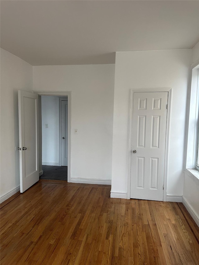 unfurnished room featuring hardwood / wood-style flooring