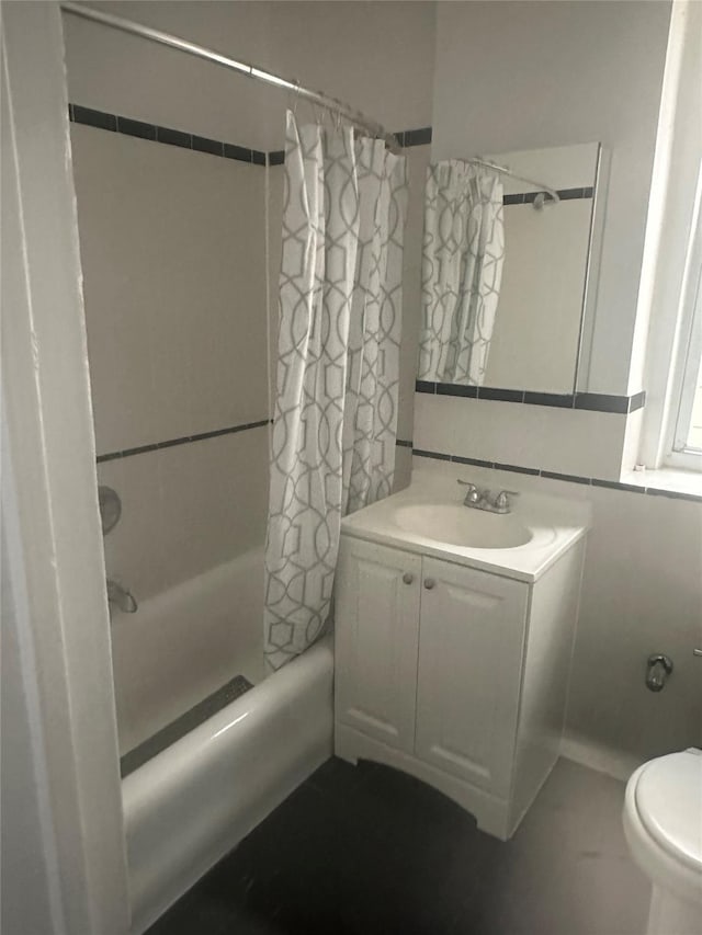 full bathroom with shower / bath combo, vanity, and toilet