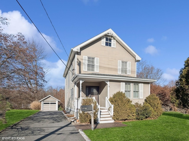 front of property featuring a front lawn, an outdoor structure, and a garage