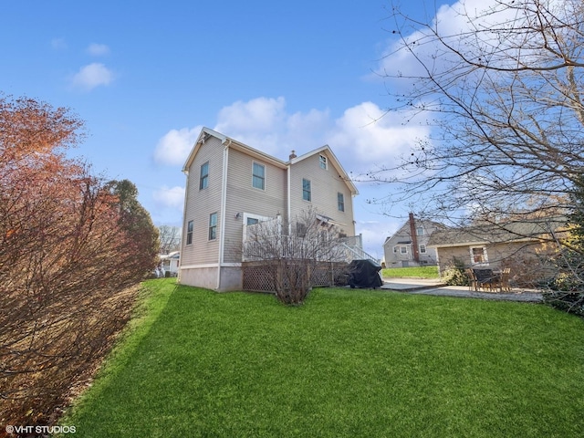 rear view of property featuring a lawn