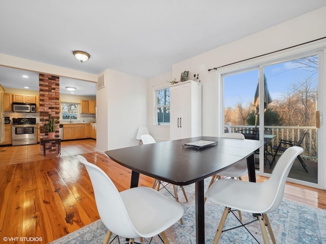 dining room featuring light wood-type flooring and sink