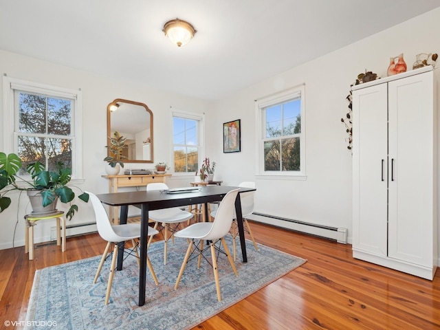 dining room featuring hardwood / wood-style flooring and a baseboard heating unit