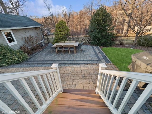 wooden deck with a patio area and a yard