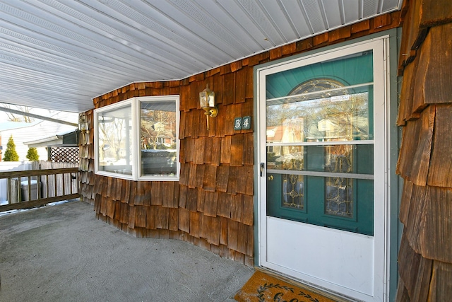 view of exterior entry featuring a porch