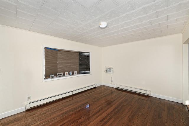 spare room with dark hardwood / wood-style flooring and a baseboard radiator