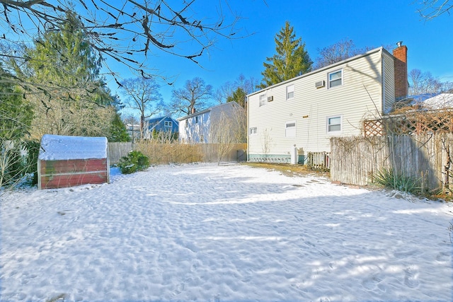 view of snow covered rear of property