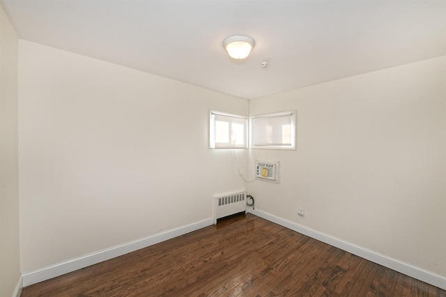 washroom with dark hardwood / wood-style flooring and radiator