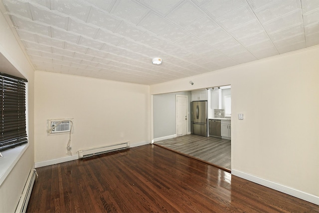 empty room featuring a wall mounted AC, dark hardwood / wood-style flooring, and a baseboard radiator