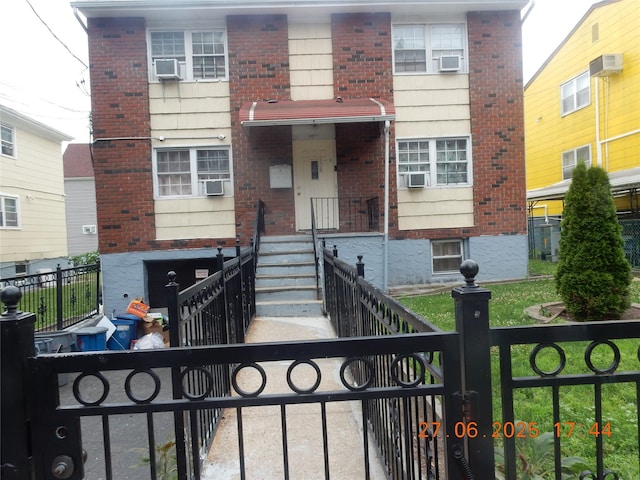 128 E 4th St, Mount Vernon, NY 10550 - view of front of home with brick siding and a fenced front yard