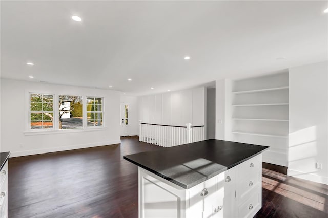 kitchen featuring white cabinetry, a kitchen island, and dark hardwood / wood-style floors