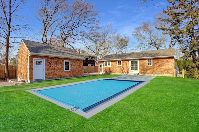 back of property with a lawn, a fenced in pool, and a patio