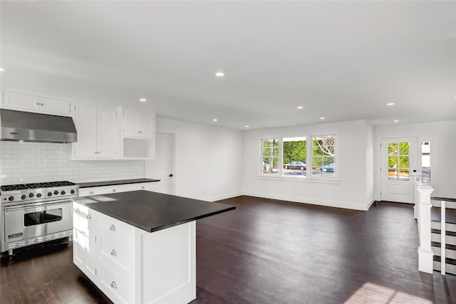 kitchen with a kitchen island, dark hardwood / wood-style flooring, backsplash, designer range, and white cabinets